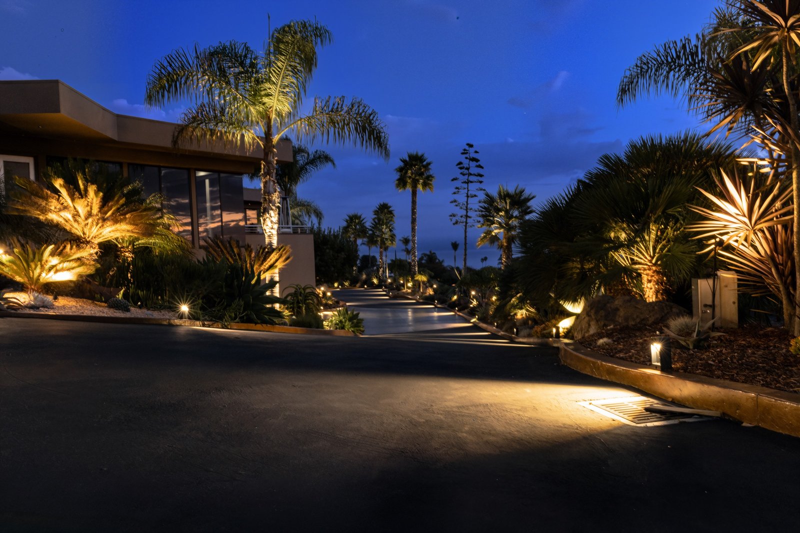 Illuminated waterfall and pool at dusk