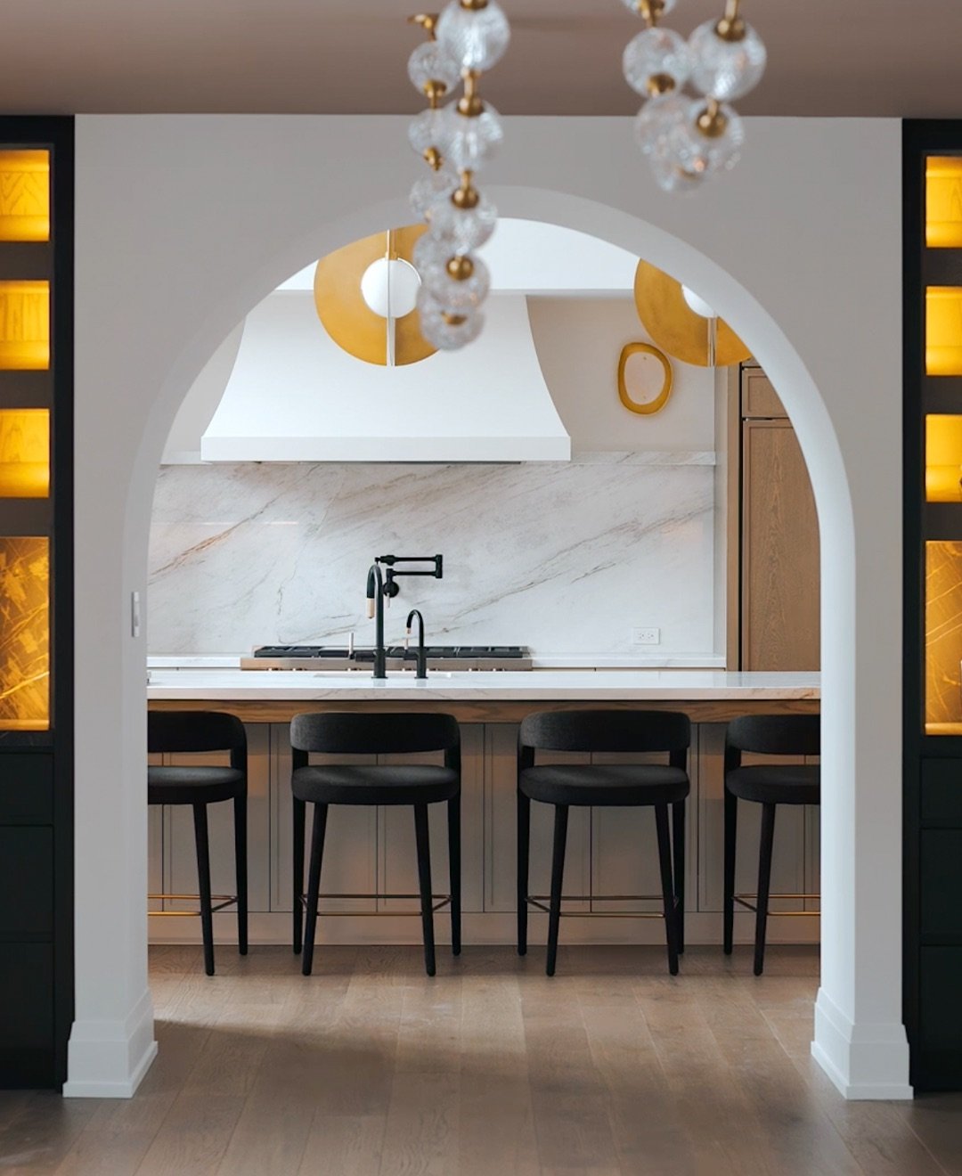 Luxury interior kitchen with marble, arch, and gold accents